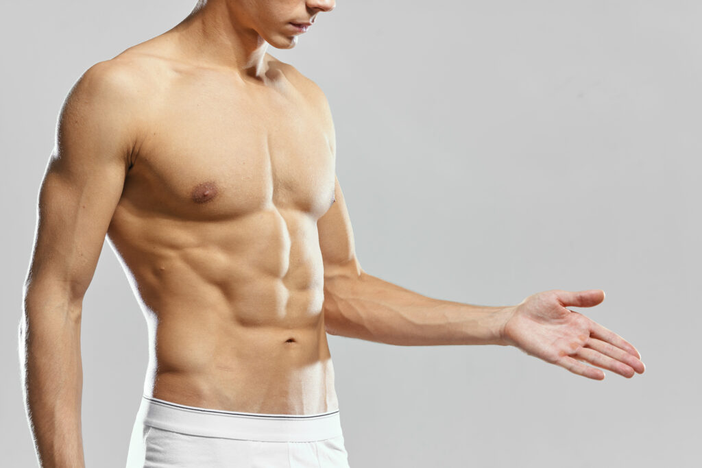 male athlete in white shorts pumped up press posing